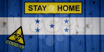 Flag of the Honduras in original proportions. Quarantine and isolation - Stay at home. flag with biohazard symbol and inscription COVID-19.