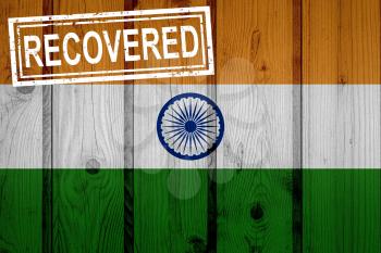 flag of India that survived or recovered from the infections of corona virus epidemic or coronavirus. Grunge flag with stamp Recovered