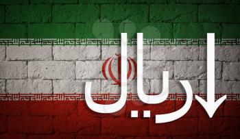 symbolic depreciation of the national currency Rial against of the country flag of Iran. Concept of depreciation of currency, economy fall and the breakdown of economic ties