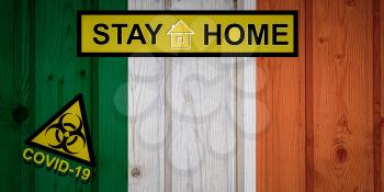 Flag of the Ireland in original proportions. Quarantine and isolation - Stay at home. flag with biohazard symbol and inscription COVID-19.