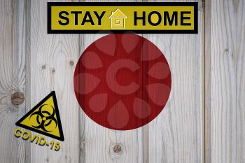 Flag of the Japan in original proportions. Quarantine and isolation - Stay at home. flag with biohazard symbol and inscription COVID-19.