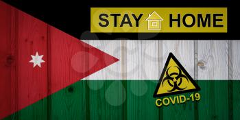 Flag of the Jordan in original proportions. Quarantine and isolation - Stay at home. flag with biohazard symbol and inscription COVID-19.