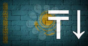 symbolic depreciation of the national currency Tenge against of the country flag Kazakhstan. Concept of depreciation of currency, economy fall and the breakdown of economic ties