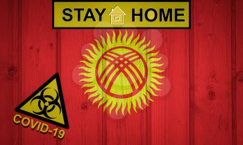 Flag of the Kyrgyzstan in original proportions. Quarantine and isolation - Stay at home. flag with biohazard symbol and inscription COVID-19.