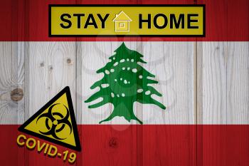 Flag of the Lebanon in original proportions. Quarantine and isolation - Stay at home. flag with biohazard symbol and inscription COVID-19.