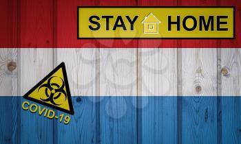 Flag of the Luxembourg in original proportions. Quarantine and isolation - Stay at home. flag with biohazard symbol and inscription COVID-19.