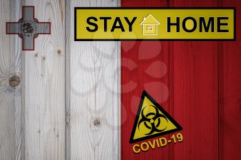 Flag of the Malta in original proportions. Quarantine and isolation - Stay at home. flag with biohazard symbol and inscription COVID-19.