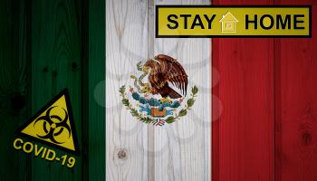Flag of the Mexico in original proportions. Quarantine and isolation - Stay at home. flag with biohazard symbol and inscription COVID-19.