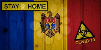 Flag of the Moldova in original proportions. Quarantine and isolation - Stay at home. flag with biohazard symbol and inscription COVID-19.