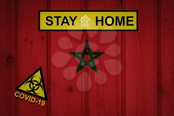 Flag of the Morocco in original proportions. Quarantine and isolation - Stay at home. flag with biohazard symbol and inscription COVID-19.
