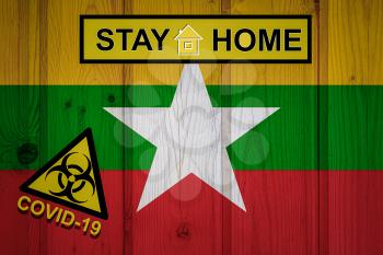 Flag of the Myanmar in original proportions. Quarantine and isolation - Stay at home. flag with biohazard symbol and inscription COVID-19.