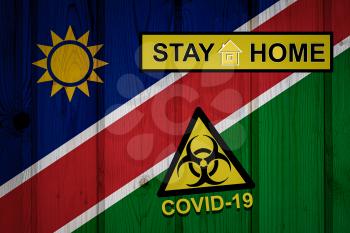 Flag of the Namibia in original proportions. Quarantine and isolation - Stay at home. flag with biohazard symbol and inscription COVID-19.