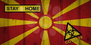 Flag of the North Macedonia in original proportions. Quarantine and isolation - Stay at home. flag with biohazard symbol and inscription COVID-19.
