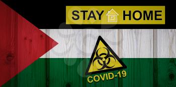 Flag of the Palestine in original proportions. Quarantine and isolation - Stay at home. flag with biohazard symbol and inscription COVID-19.