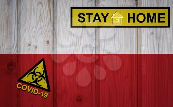 Flag of the Poland in original proportions. Quarantine and isolation - Stay at home. flag with biohazard symbol and inscription COVID-19.