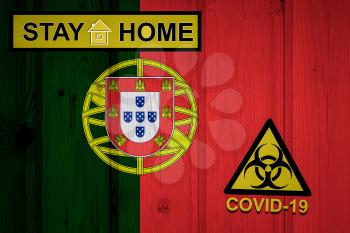 Flag of the Portugal in original proportions. Quarantine and isolation - Stay at home. flag with biohazard symbol and inscription COVID-19.