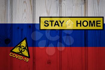 Flag of the Russia in original proportions. Quarantine and isolation - Stay at home. flag with biohazard symbol and inscription COVID-19.