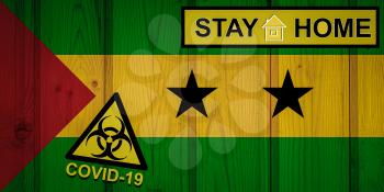 Flag of the Sao Tome and Principe in original proportions. Quarantine and isolation - Stay at home. flag with biohazard symbol and inscription COVID-19.