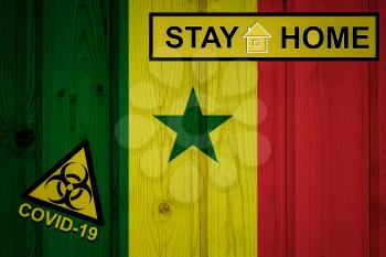 Flag of the Senegal in original proportions. Quarantine and isolation - Stay at home. flag with biohazard symbol and inscription COVID-19.