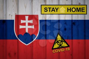 Flag of the Slovakia in original proportions. Quarantine and isolation - Stay at home. flag with biohazard symbol and inscription COVID-19.