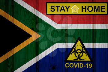 Flag of the South Africa in original proportions. Quarantine and isolation - Stay at home. flag with biohazard symbol and inscription COVID-19.