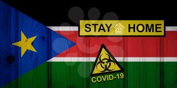 Flag of the South Sudan in original proportions. Quarantine and isolation - Stay at home. flag with biohazard symbol and inscription COVID-19.