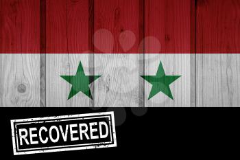 flag of Syria that survived or recovered from the infections of corona virus epidemic or coronavirus. Grunge flag with stamp Recovered