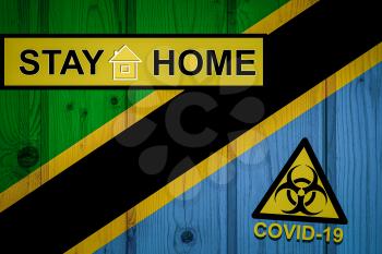 Flag of the Tanzania in original proportions. Quarantine and isolation - Stay at home. flag with biohazard symbol and inscription COVID-19.
