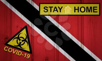 Flag of the Trinidad and Tobago in original proportions. Quarantine and isolation - Stay at home. flag with biohazard symbol and inscription COVID-19.