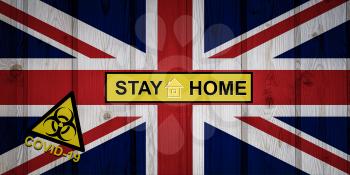 Flag of the United Kingdom in original proportions. Quarantine and isolation - Stay at home. flag with biohazard symbol and inscription COVID-19.