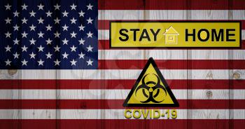 Flag of the United States in original proportions. Quarantine and isolation - Stay at home. flag with biohazard symbol and inscription COVID-19.