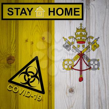 Flag of the Vatican City in original proportions. Quarantine and isolation - Stay at home. flag with biohazard symbol and inscription COVID-19.