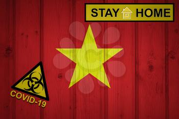 Flag of the Vietnam in original proportions. Quarantine and isolation - Stay at home. flag with biohazard symbol and inscription COVID-19.