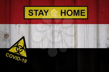 Flag of the Yemen in original proportions. Quarantine and isolation - Stay at home. flag with biohazard symbol and inscription COVID-19.