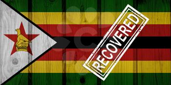 flag of Zimbabwe that survived or recovered from the infections of corona virus epidemic or coronavirus. Grunge flag with stamp Recovered