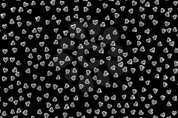 Valentine's Day abstract 3D illustration pattern with silver or gray metallic hearts on black background.