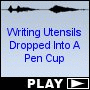 Writing Utensils Dropped Into A Pen Cup