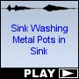 Sink Washing Metal Pots in Sink