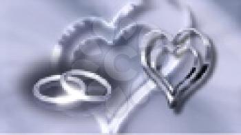 Royalty Free Video of Silver Rotating Hearts and Wedding Rings